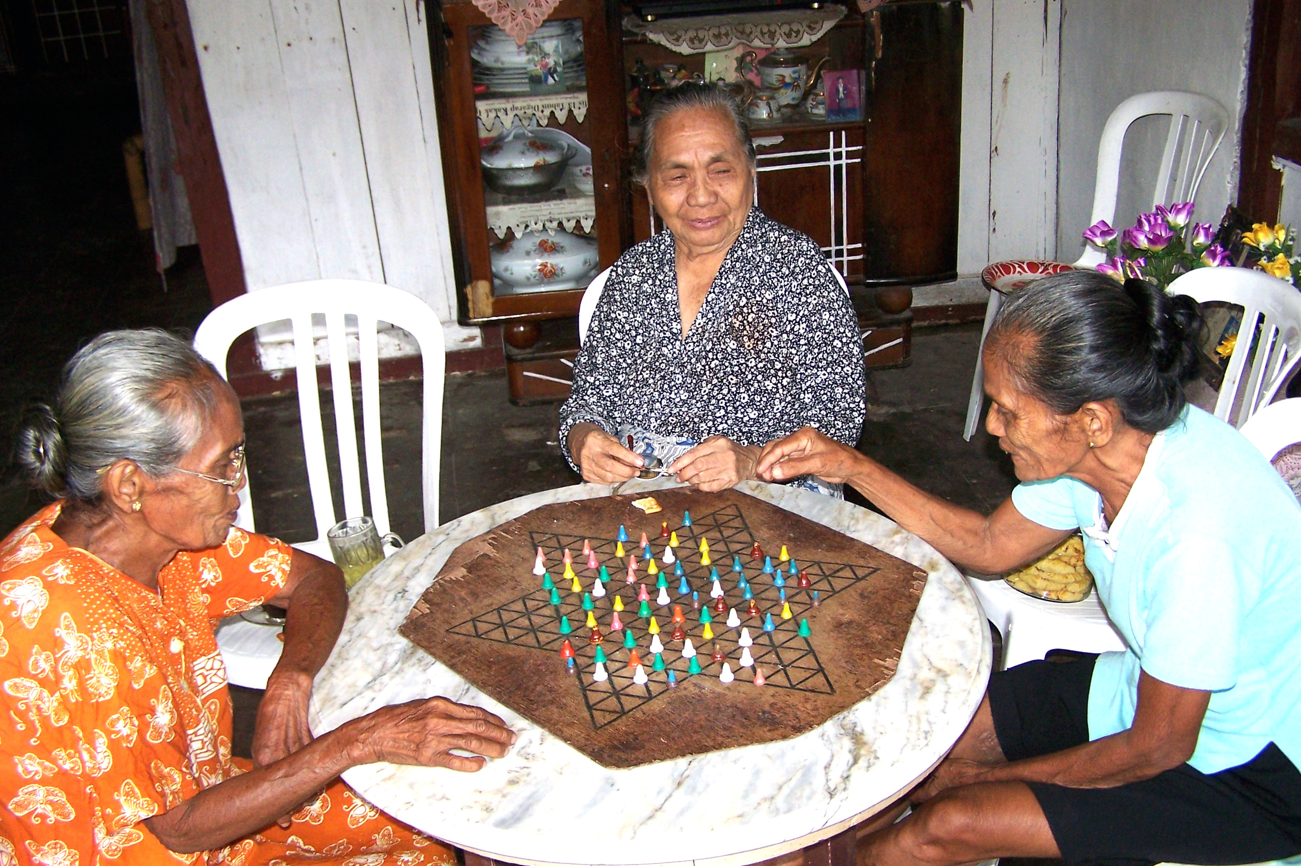Three elderly women visit in Siau